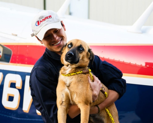 Pilots to the Rescue aviator with rescue dog